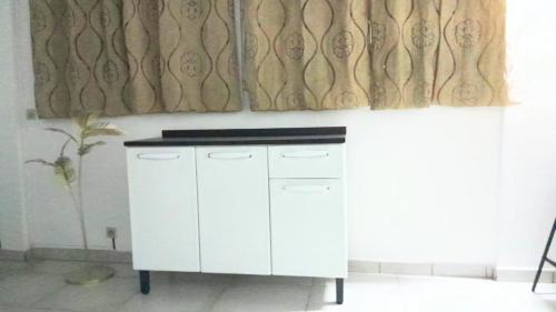 a white cabinet in a room with a window at Dolce Pace Kreyol in Cayenne