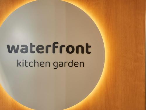 a sign that reads waterford kitchen garden with the sun at Kansai Airport Washington Hotel in Izumi-Sano