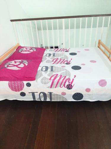 a crib with a hello kitty blanket on it at Dolce Pace Kreyol in Cayenne