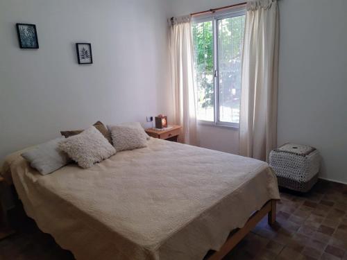 a bedroom with a large bed and a window at Casa Emilia Tanti in Tanti