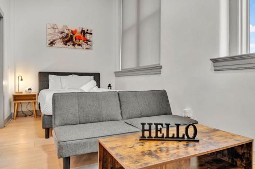 a living room with a couch and a bed at Bright and Modern Studio in Louisville # 304 in Louisville
