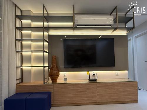 a living room with a flat screen tv on a wall at Cais Eco Resort in Porto De Galinhas