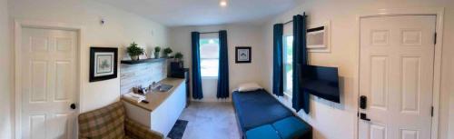 a room with a blue couch and a sink and a door at Elenem Resort in Magalang