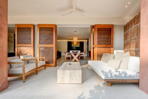 a living room with a couch and a table at El Careyes Club & Residences in Careyes