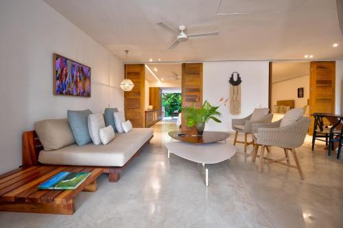 a living room with a couch and a table at El Careyes Club & Residences in Careyes