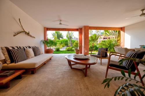 a living room with a couch and a table at El Careyes Club & Residences in Careyes