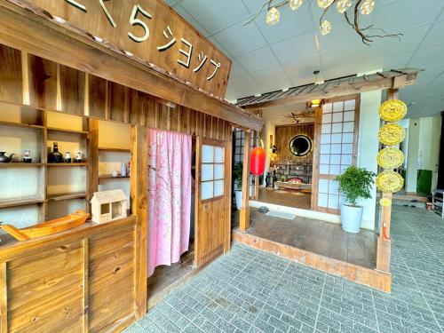 a room with a store with a counter with a microwave at SAKURA House ĐÀ LẠT in Da Lat