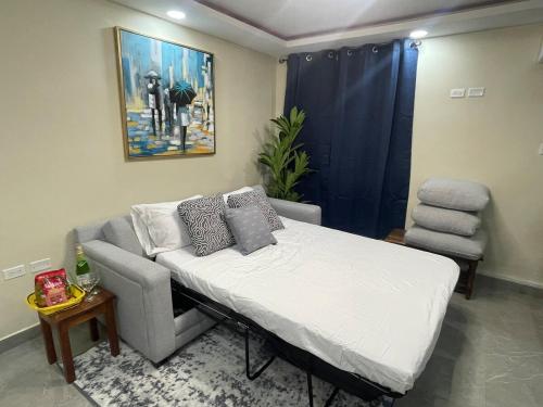 a bedroom with a bed and a chair in it at Modern Kingston Apartment Suite With Pool & Ocean View in Kingston