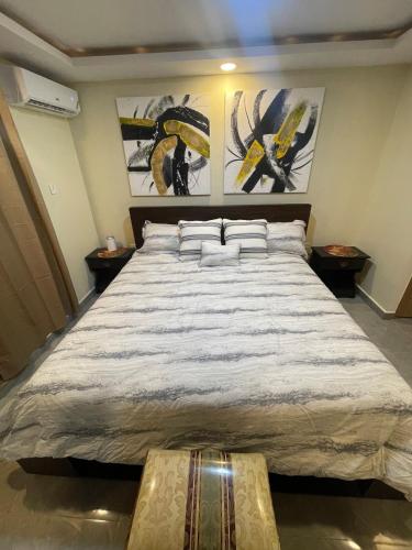 a bedroom with a large bed with two pillows at Modern Kingston Apartment Suite With Pool & Ocean View in Kingston