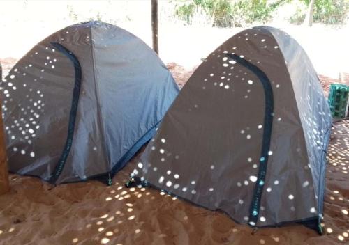 two tents sitting in the sand in the rain at Gokarna Glimpse Getaway in Gokarna