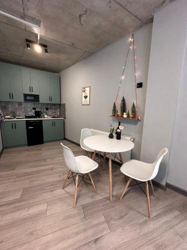 a room with two tables and chairs and a kitchen at Maximus apartments in Mestia in Mestia