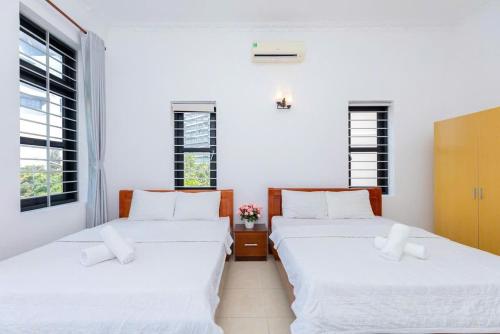 Postel nebo postele na pokoji v ubytování Kegotel Villa Bãi Sau - Central 01