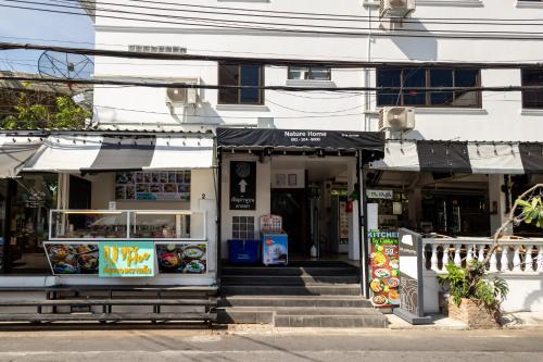 a building with a food stand in front of it at Nature Boutique Residence in Bangkok