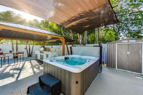 a jacuzzi tub on a deck with a patio at Luxurious Tropical Private Oasis by Mia Airport in Hialeah
