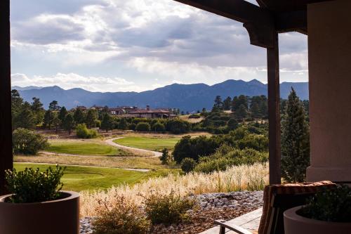 a view of a golf course from the porch of a house at Flying Horse Resort & Club in Colorado Springs