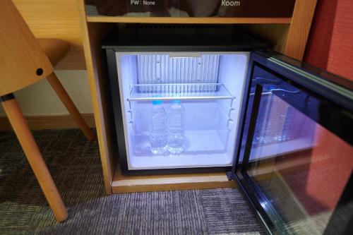 a small refrigerator with a bottle of water in it at Dormy Inn EXPRESS SEOUL Insadong in Seoul