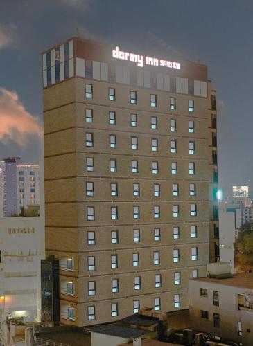 a building with a sign on the side of it at Dormy Inn EXPRESS SEOUL Insadong in Seoul