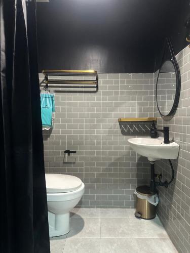 a bathroom with a white toilet and a sink at The Hidden Gem Poshtel Koh Tao in Koh Tao