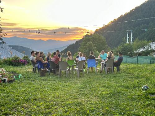 a group of people sitting at tables on a hill at Hotel Restaurant Radomira in Ceren