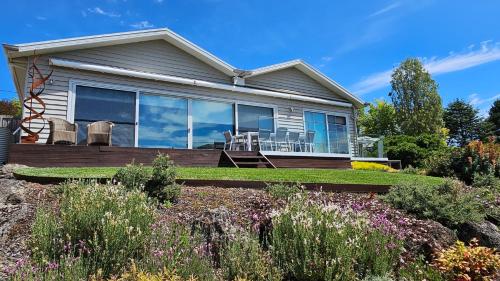 a house with a deck with chairs on it at Province Lake House in Daylesford