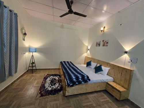 比尔瓦Siddhartha Greens Resort Bir Billing Amidst Tea Garden的带床和吊扇的卧室