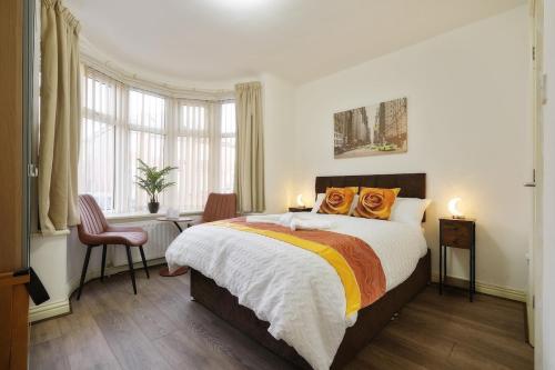 a bedroom with a large bed with orange pillows at Comfortable Ensuite Rooms and Ample Street Parking in Doncaster