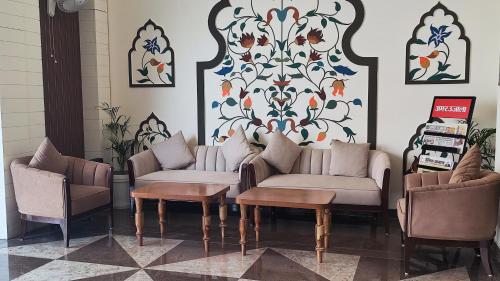 a living room with two couches and a table and chairs at raghukul sadan in Faizābād