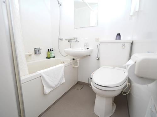 a white bathroom with a toilet and a sink at Hotel Areaone Okayama - Vacation STAY 32495v in Okayama