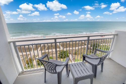 two chairs and a bench on a balcony overlooking the beach at Atlantica 753 in Myrtle Beach