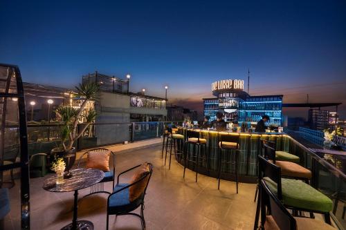 a rooftop bar with tables and chairs on a building at Le Premier Hotel & Rooftop Bar in Hanoi