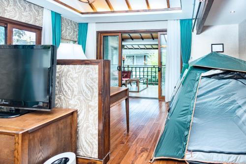 a tent in a living room with a tv at 丽江束河元年别院 Yuannian Lijiang in Lijiang