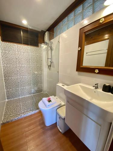 a bathroom with a toilet and a sink and a shower at Baan Laem Noi Villa's in Mae Nam