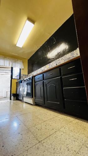 a row of black cabinets in a kitchen at Casa Dahlia Querétaro in Querétaro