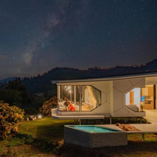 a house with a swimming pool at night at Sky View Mon Jam in Chiang Mai