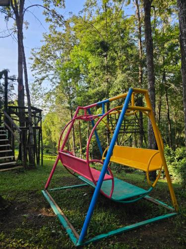 a colorful swing set in a park at LUSHOTO EXECUTIVE LODGE in Lushoto