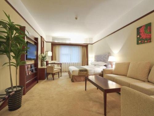 a hotel room with a bed and a couch at Starmoon Hotel in Beijing