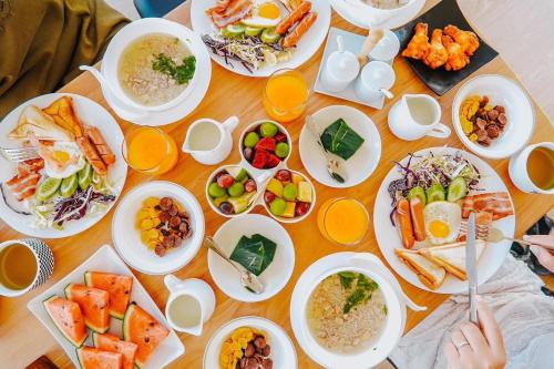 a table with plates of food and bowls of food at Sky View Mon Jam in Chiang Mai