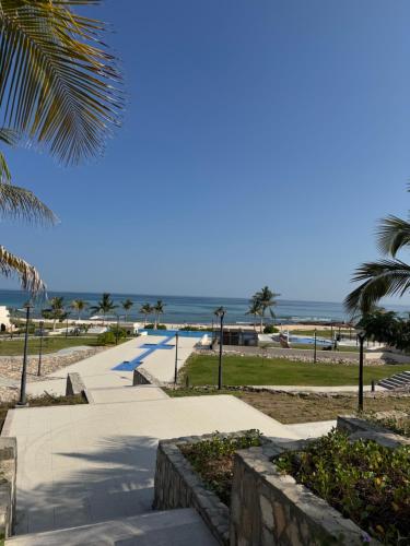 a pathway to the beach with the ocean in the background at Beach house بيت البحر in As Sīfah