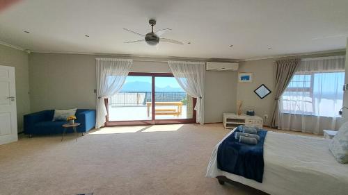 a bedroom with a bed and a view of the ocean at Grace Space in Plattekloof in Cape Town