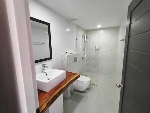 a white bathroom with a sink and a toilet at Crystal Bay Yacht Club Beach Resort in Lamai