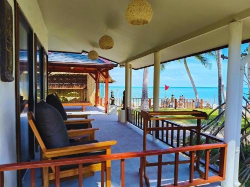 a view of the beach from the porch of a resort at Crystal Bay Yacht Club Beach Resort in Lamai