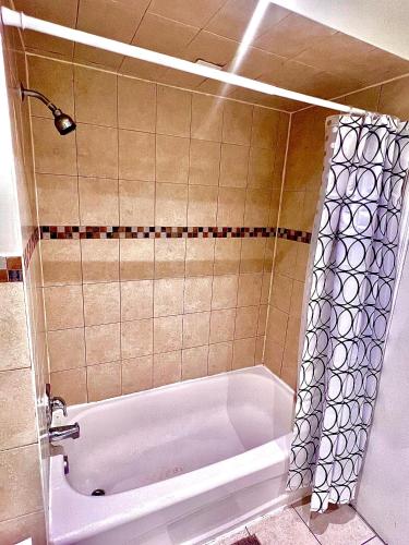 a bathroom with a bath tub with a shower at Private Room Near Airport D1 in Brampton