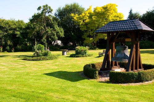 a gazebo with a bell in a park at Haus Schlesien in Königswinter
