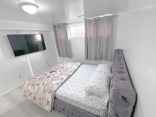 a bedroom with a bed and a television in it at Private Room Near Airport D5 in Brampton