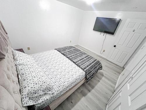 a bedroom with a bed and a flat screen tv at Private Room Near Airport D8 in Brampton