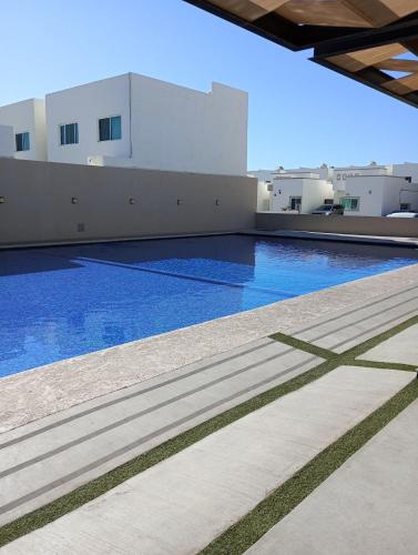 a swimming pool on the roof of a building at Casa con casa club en la Paz BCS in La Paz