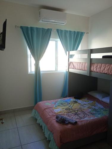 a bedroom with a bunk bed and a window at Casa con casa club en la Paz BCS in La Paz