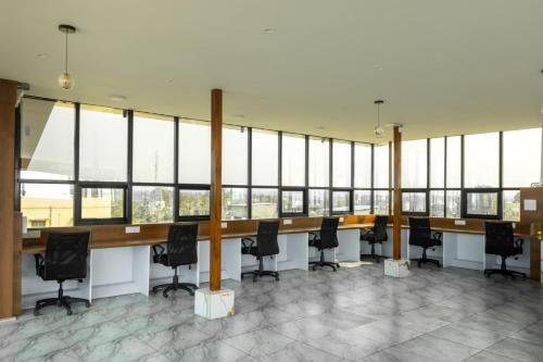 a conference room with a long table and black chairs at Bharath Pods in Coimbatore