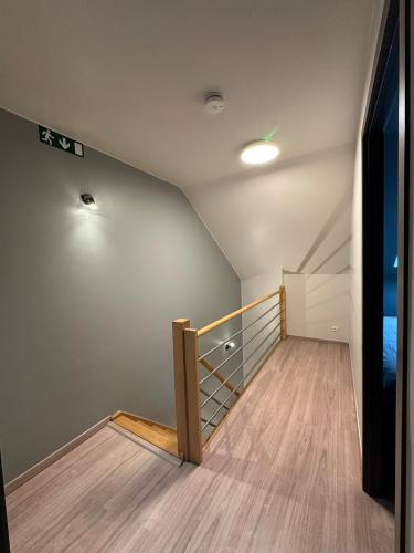 an empty room with a staircase and a television at The175 work or holiday home in Comines
