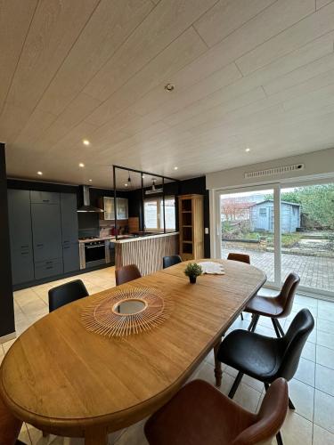 a kitchen and dining room with a wooden table and chairs at The175 work or holiday home in Comines